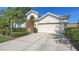 Charming home exterior with two car garage, lush landscaping, and a well maintained driveway at 6721 Oak Manor Dr, Lakewood Ranch, FL 34202