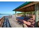 Tranquil lakeside gazebo with seating and a ceiling fan providing shade and a peaceful setting by the lake at 6721 Oak Manor Dr, Lakewood Ranch, FL 34202