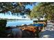 Lakeside view featuring kayaks with shade trees along a sidewalk for outdoor recreation near the water at 6721 Oak Manor Dr, Lakewood Ranch, FL 34202