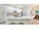 Modern kitchen with white cabinets, stainless steel appliances, and a spacious quartz countertop island at 6721 Oak Manor Dr, Lakewood Ranch, FL 34202