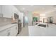Bright kitchen featuring white cabinets, stainless steel appliances, and quartz countertops at 6721 Oak Manor Dr, Lakewood Ranch, FL 34202