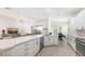 Open-concept kitchen with sleek white cabinets, stainless steel appliances, and a large island at 6721 Oak Manor Dr, Lakewood Ranch, FL 34202