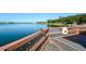 A great blue heron sits on the railing of a dock on a glassy lake reflecting the blue sky at 6721 Oak Manor Dr, Lakewood Ranch, FL 34202