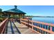 Charming gazebo on a wooden dock overlooking a serene lake with seating for enjoying the views at 6721 Oak Manor Dr, Lakewood Ranch, FL 34202