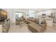 Bright living room with a large sectional, a modern kitchen, and an open floor plan at 6721 Oak Manor Dr, Lakewood Ranch, FL 34202