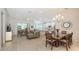 Open-concept living space featuring a comfortable sectional, dining area, and modern kitchen at 6721 Oak Manor Dr, Lakewood Ranch, FL 34202