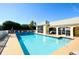 Community pool with sparkling water, lounge chairs, and a building for community members at 6721 Oak Manor Dr, Lakewood Ranch, FL 34202