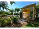 Pool house featuring an arched entry, palm trees, and a landscaped area at 6721 Oak Manor Dr, Lakewood Ranch, FL 34202