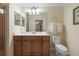 Bathroom featuring a wooden vanity, white countertops, and a framed mirror at 7005 River Hammock Dr # 203, Bradenton, FL 34212