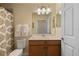 Bathroom featuring a white vanity, patterned shower curtain, and framed mirror at 7005 River Hammock Dr # 203, Bradenton, FL 34212