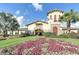 Elegant clubhouse with beautiful landscaping and colorful flowers in a welcoming setting at 7005 River Hammock Dr # 203, Bradenton, FL 34212
