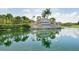 Elegant entrance to Heritage Harbour with a reflective water feature and manicured landscaping at 7005 River Hammock Dr # 203, Bradenton, FL 34212