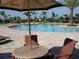 Inviting community pool with ample seating and lush landscaping for relaxation and enjoyment at 7005 River Hammock Dr # 203, Bradenton, FL 34212