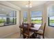 Cozy dining area featuring a wood table, four chairs, and scenic outdoor views at 7005 River Hammock Dr # 203, Bradenton, FL 34212