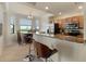 Open-concept kitchen with granite countertops, stainless steel appliances, and dining area at 7005 River Hammock Dr # 203, Bradenton, FL 34212