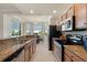 Well-equipped kitchen with granite counters, stainless appliances, and a view to the dining area at 7005 River Hammock Dr # 203, Bradenton, FL 34212