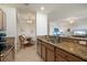 Open kitchen with granite counters, stainless appliances, and a view to dining and living spaces at 7005 River Hammock Dr # 203, Bradenton, FL 34212
