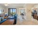 Bright living room with tiled floors, stylish furniture and serene views of the lake and surroundings at 7005 River Hammock Dr # 203, Bradenton, FL 34212