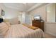 Relaxing bedroom with a cozy bed, dresser, and view to an ensuite bathroom at 7005 River Hammock Dr # 203, Bradenton, FL 34212