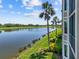Scenic view of a tranquil pond bordered by a golf course and tropical foliage at 7005 River Hammock Dr # 203, Bradenton, FL 34212
