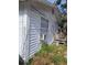 Exterior home view showing peeling paint and overgrown landscape at 710 25Th W Ave, Bradenton, FL 34205