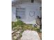 Exterior view of home with overgrown landscaping and peeling paint at 710 25Th W Ave, Bradenton, FL 34205