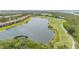 Community aerial showcases residences with views of a serene lake and well-manicured golf course at 7235 River Hammock Dr # 204, Bradenton, FL 34212