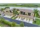 Scenic aerial view of condo community with lush landscaping, lake views, and tile roofs at 7235 River Hammock Dr # 204, Bradenton, FL 34212