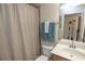 Neutral-toned bathroom features a shower with curtain and vanity with sink at 7235 River Hammock Dr # 204, Bradenton, FL 34212