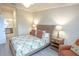 Inviting bedroom with natural light, rattan bed frame, and side tables at 7235 River Hammock Dr # 204, Bradenton, FL 34212