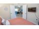 View from bedroom through french doors to living room and balcony beyond at 7235 River Hammock Dr # 204, Bradenton, FL 34212