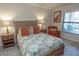 Charming bedroom with natural light, decorative pillows, and wooden furniture at 7235 River Hammock Dr # 204, Bradenton, FL 34212