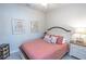 Cozy bedroom with a queen-sized bed, bedside table, and decorative artwork at 7235 River Hammock Dr # 204, Bradenton, FL 34212