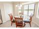 Bright dining area features large windows with pond views, creating a serene and inviting atmosphere at 7235 River Hammock Dr # 204, Bradenton, FL 34212