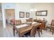 Dining room with wood table, chandelier, shell decor, and view into bedroom at 7235 River Hammock Dr # 204, Bradenton, FL 34212