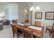 Spacious dining room with wood table, shell decor, and chandelier lighting at 7235 River Hammock Dr # 204, Bradenton, FL 34212