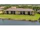 Aerial view of the back of condo building on the water with screened lanais at 7235 River Hammock Dr # 204, Bradenton, FL 34212