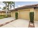 Garage and driveway in a well-maintained neighborhood with lush landscaping at 7235 River Hammock Dr # 204, Bradenton, FL 34212