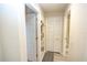 Hallway with wood-look flooring and neutral walls, with doors leading to various rooms at 7235 River Hammock Dr # 204, Bradenton, FL 34212