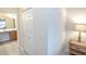 Neutral hallway with closet space leading to a bathroom with vanity at 7235 River Hammock Dr # 204, Bradenton, FL 34212