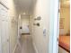 Hallway with doors, hanging decor, and view into bedroom beyond at 7235 River Hammock Dr # 204, Bradenton, FL 34212