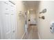 Hallway featuring wood-look flooring, and white trim plus wall decor on light-colored walls at 7235 River Hammock Dr # 204, Bradenton, FL 34212