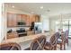 Well-equipped kitchen features stainless steel appliances, granite counters, bar seating, and adjacent dining area at 7235 River Hammock Dr # 204, Bradenton, FL 34212