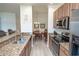 The kitchen features granite counters, stainless oven, and view to the adjacent dining room at 7235 River Hammock Dr # 204, Bradenton, FL 34212
