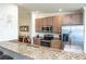 Kitchen with stainless steel appliances, granite countertops, and bar seating is perfect for casual dining at 7235 River Hammock Dr # 204, Bradenton, FL 34212