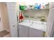 Laundry room with washer and dryer, storage shelves, and neutral walls at 7235 River Hammock Dr # 204, Bradenton, FL 34212
