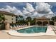 Community pool featuring plenty of lounge chairs and a covered gazebo with seating at 7235 River Hammock Dr # 204, Bradenton, FL 34212