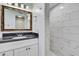 Nicely decorated bathroom features a shower and a vanity with granite countertops at 7308 Maryland Ave, Hudson, FL 34667