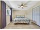 Bedroom offers a ceiling fan, wood floors, closet, and lots of natural light at 7308 Maryland Ave, Hudson, FL 34667