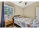 This bedroom features a window, two side tables, and nautical-themed bedding at 7308 Maryland Ave, Hudson, FL 34667